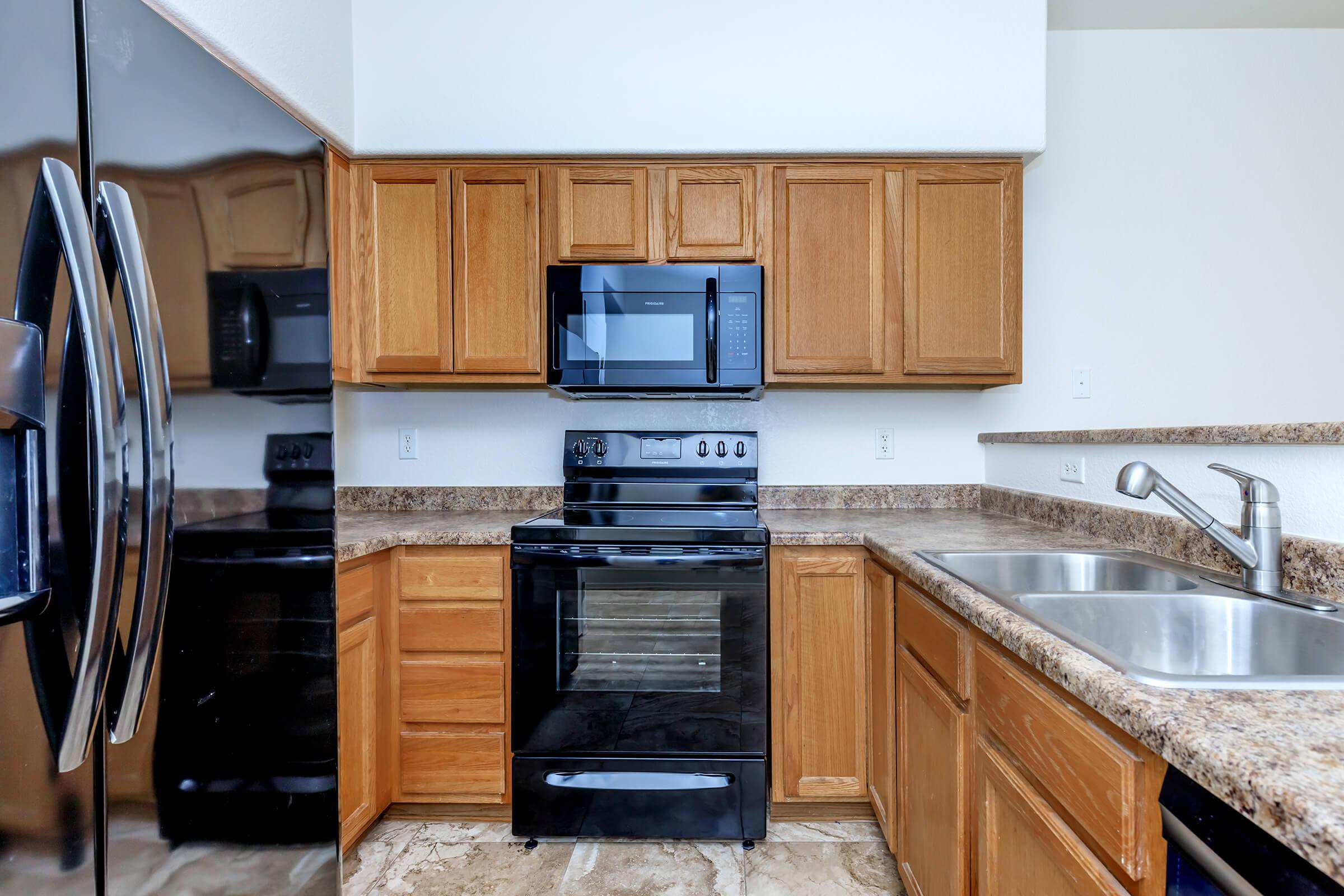 a kitchen with stainless steel appliances and wooden cabinets