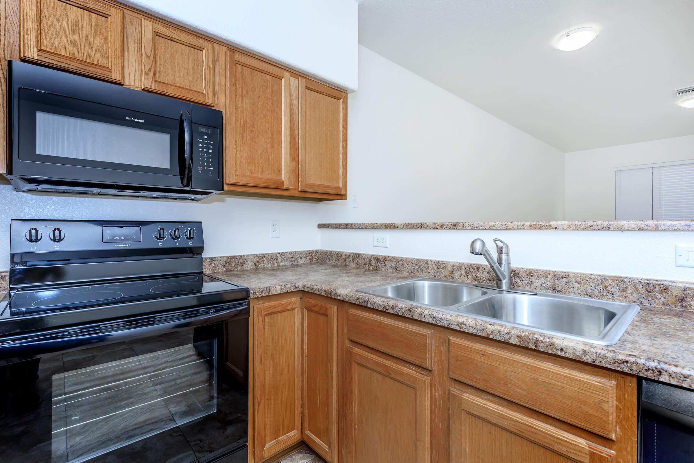 a kitchen with stainless steel appliances and wooden cabinets