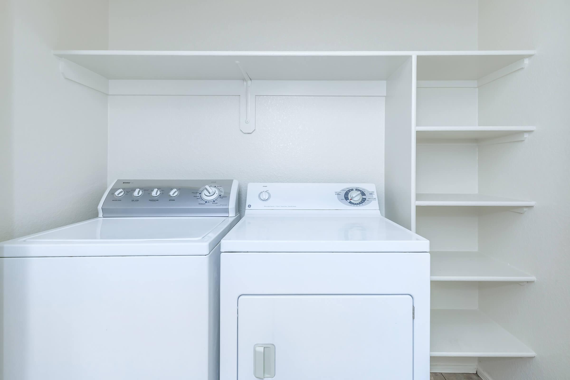 a white microwave oven sitting on top of a refrigerator