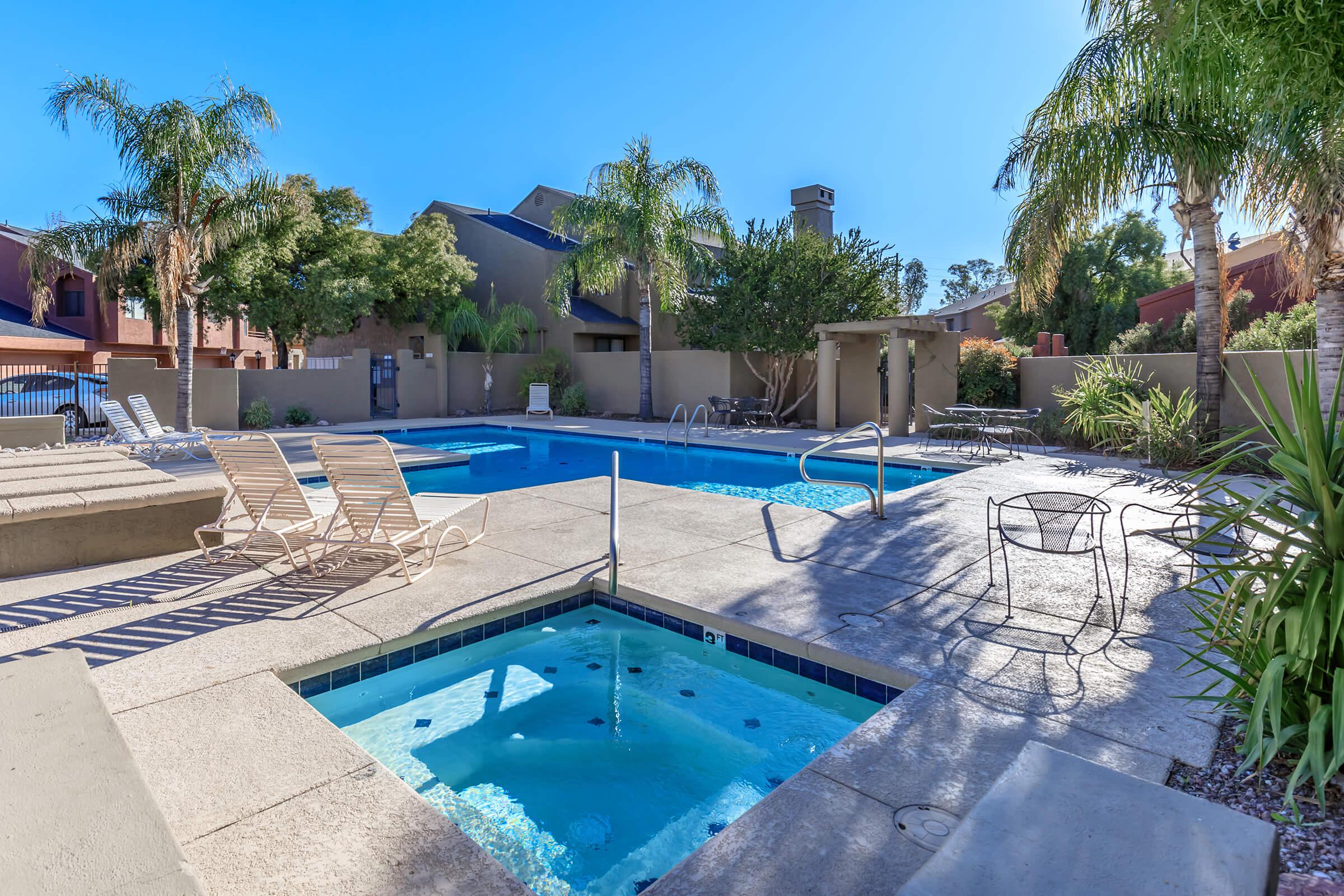 a pool next to a palm tree