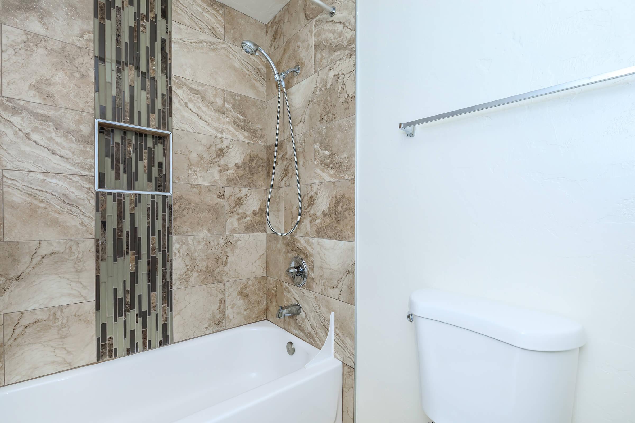 a white sink sitting next to a shower