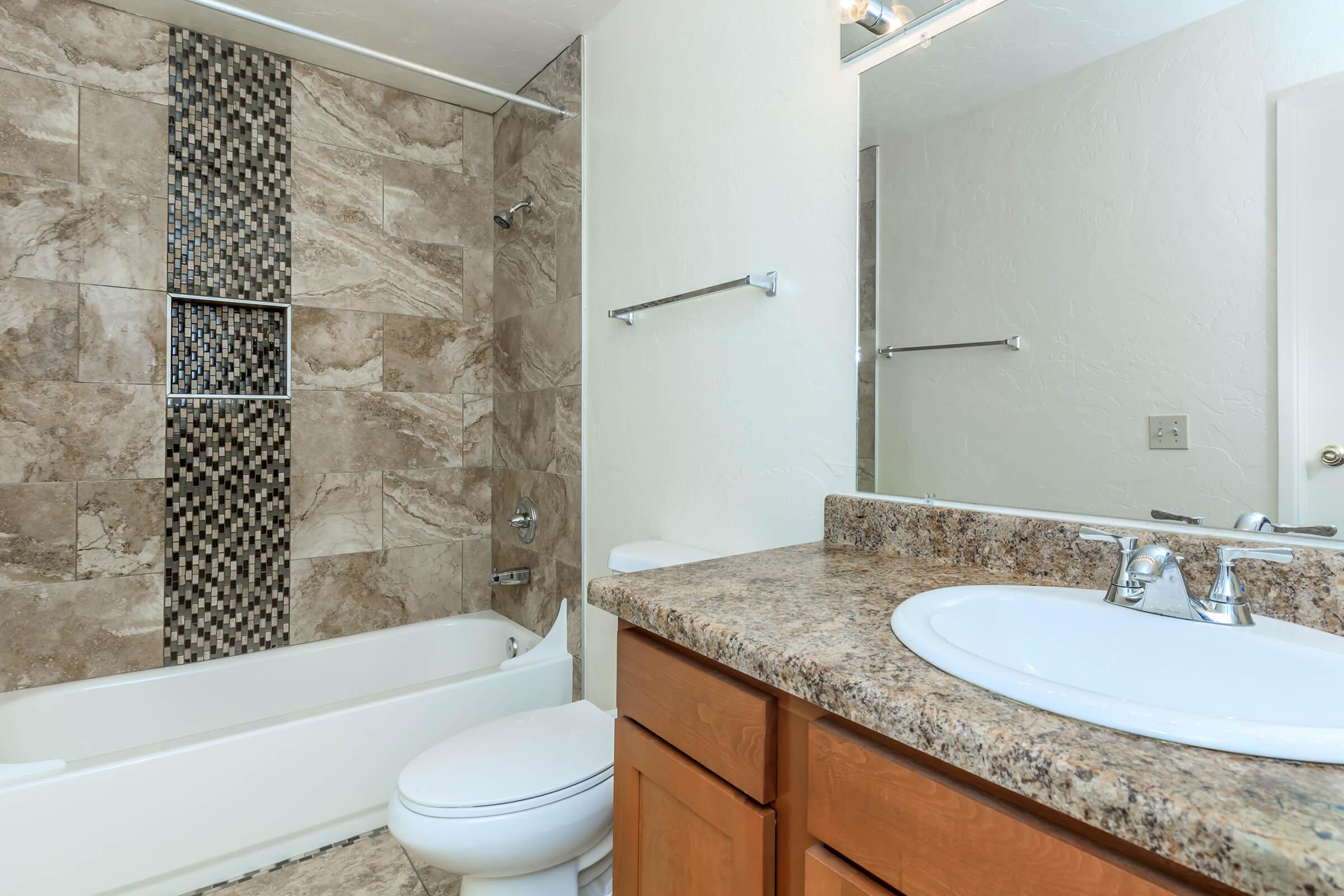 a large white tub sitting next to a sink