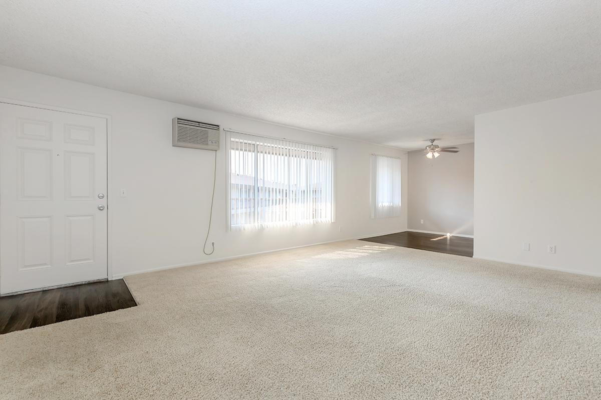 Carpeted living room with AC unit