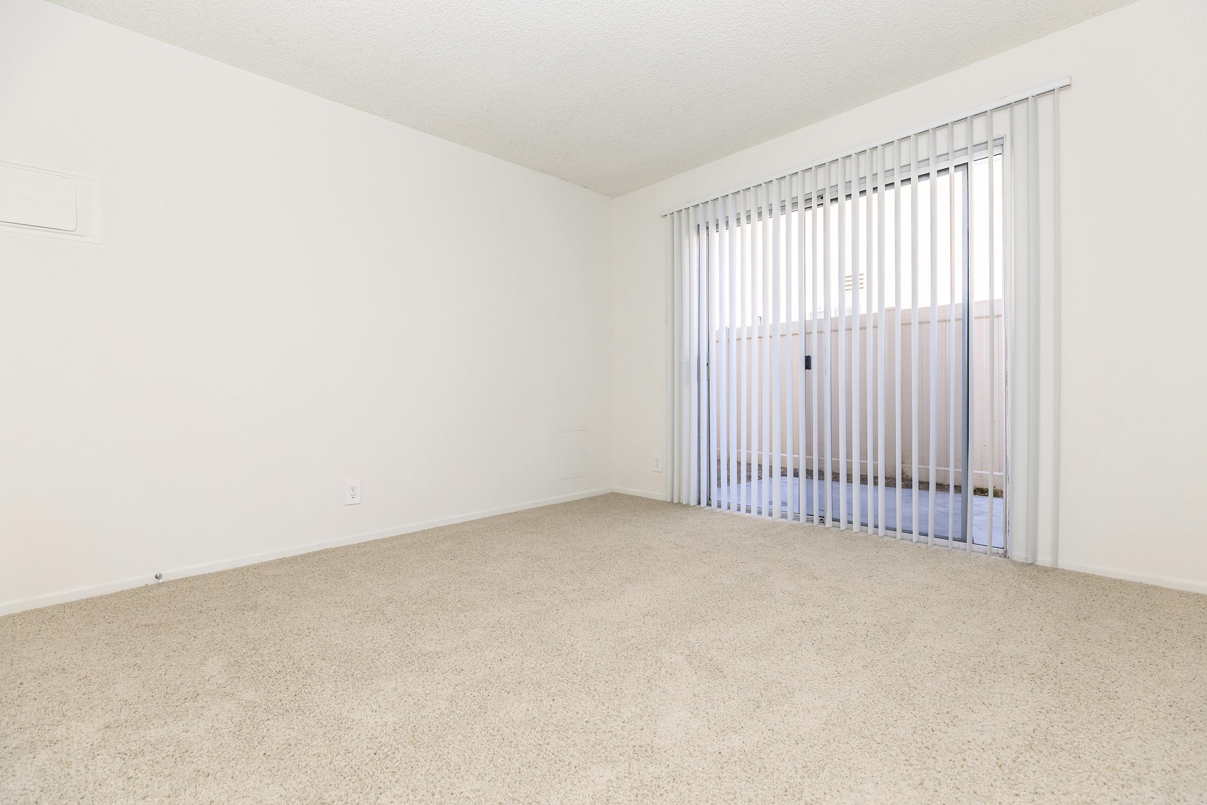 Carpeted room with sliding glass doors