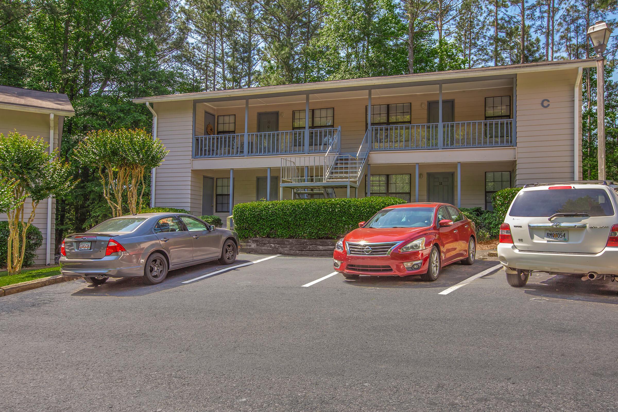 a car parked in a parking lot in front of a house