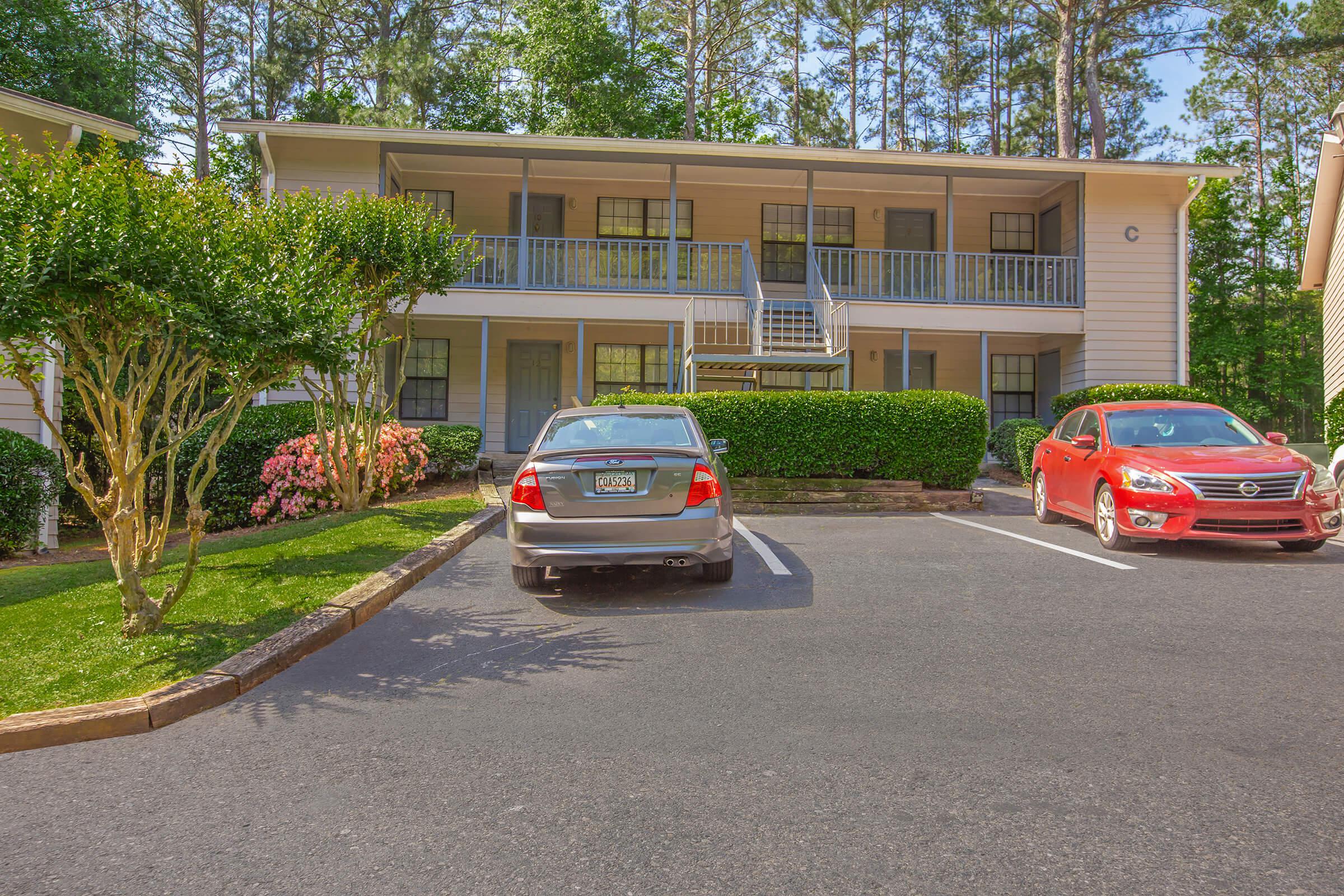 a car parked in a parking lot in front of a house