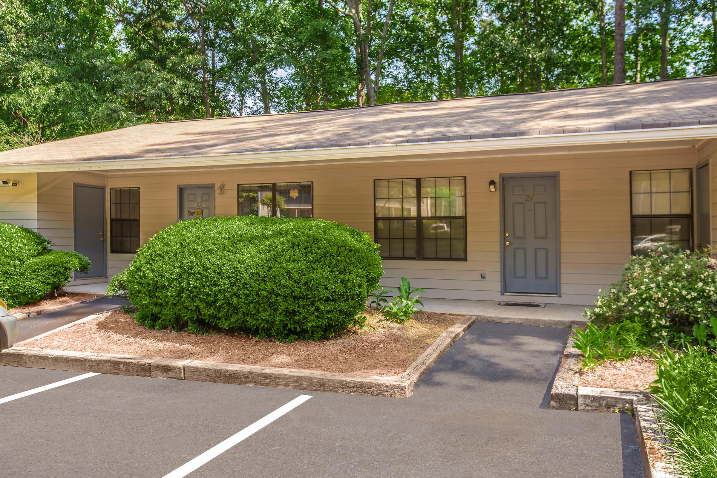 a house with bushes in front of a building