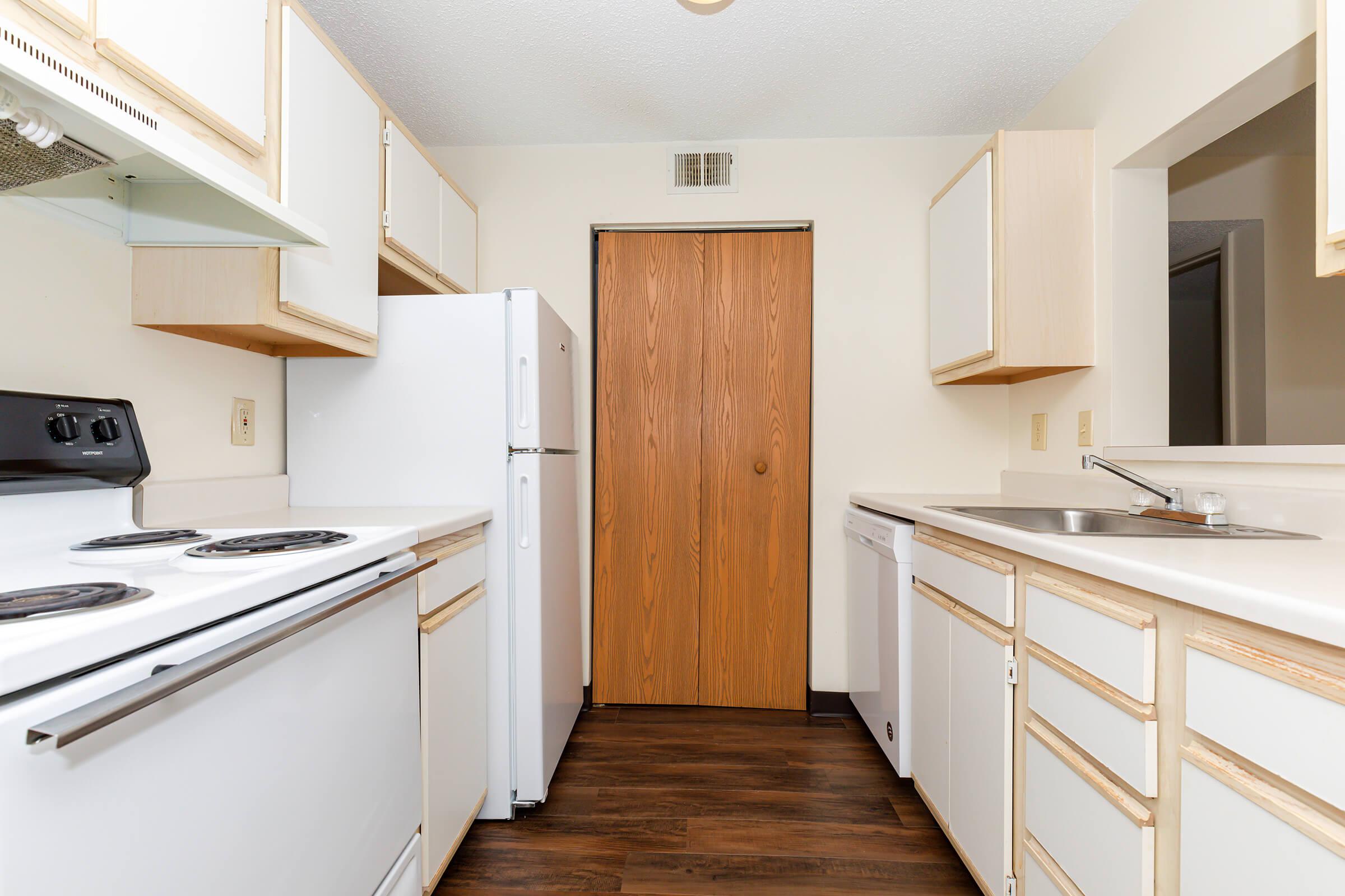 a kitchen with a stove sink and refrigerator