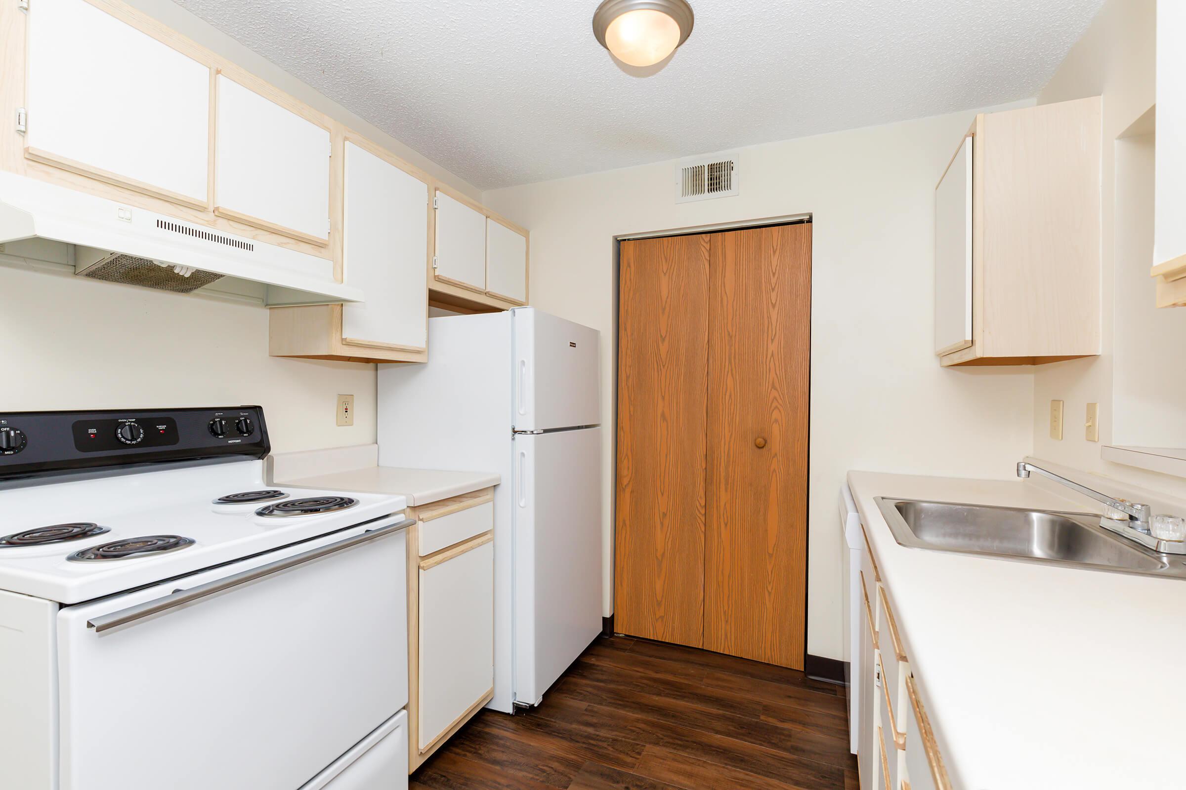 a kitchen with a stove oven and refrigerator