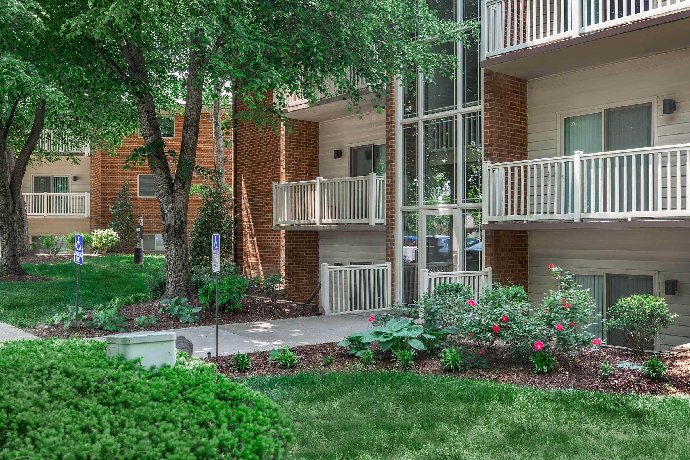 a close up of a flower garden in front of a house