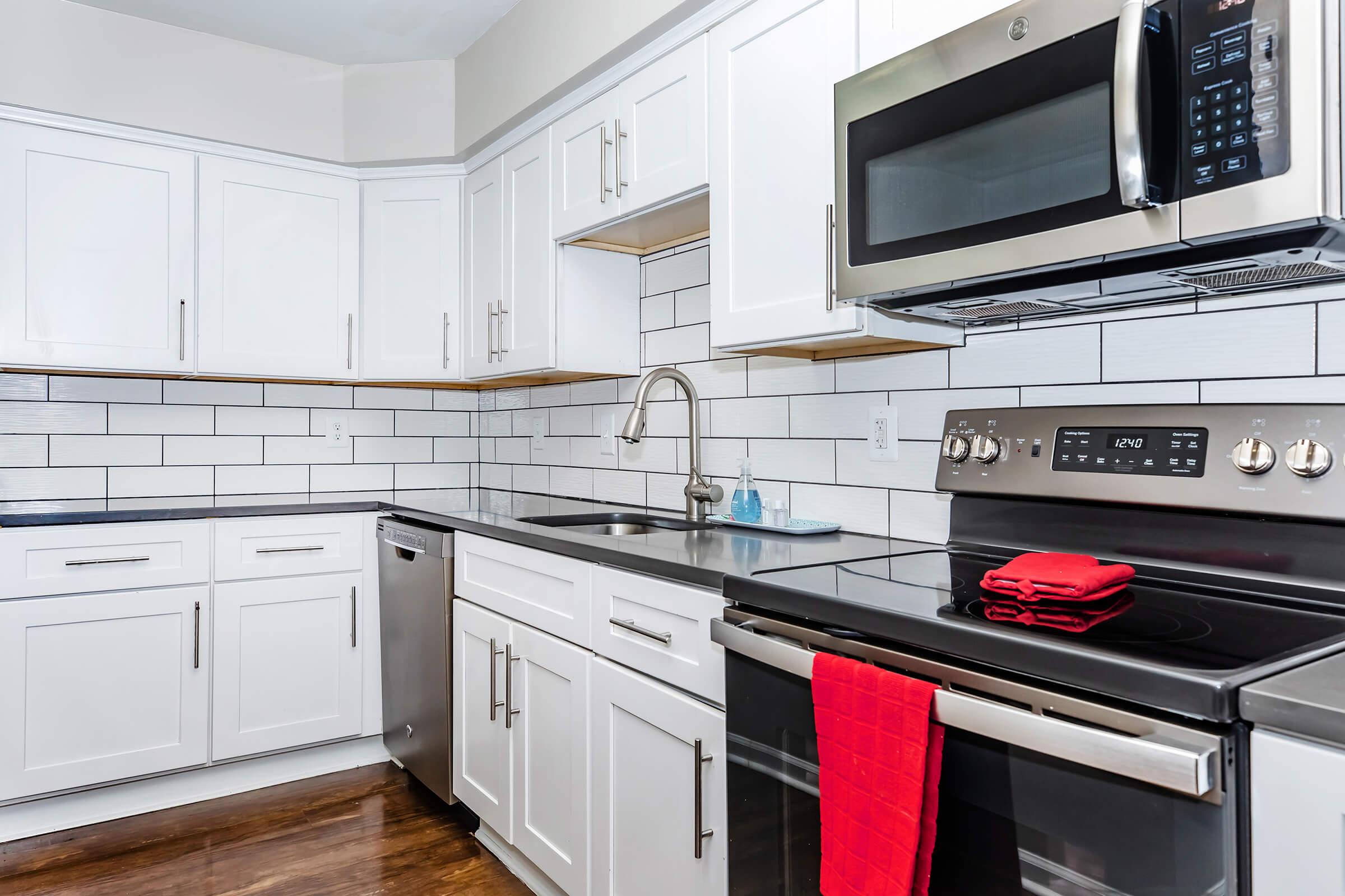 a stove top oven sitting inside of a kitchen