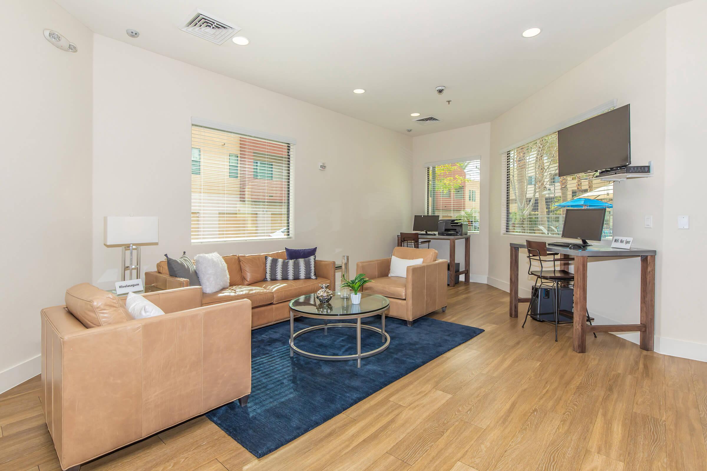 a living room filled with furniture and a wood floor