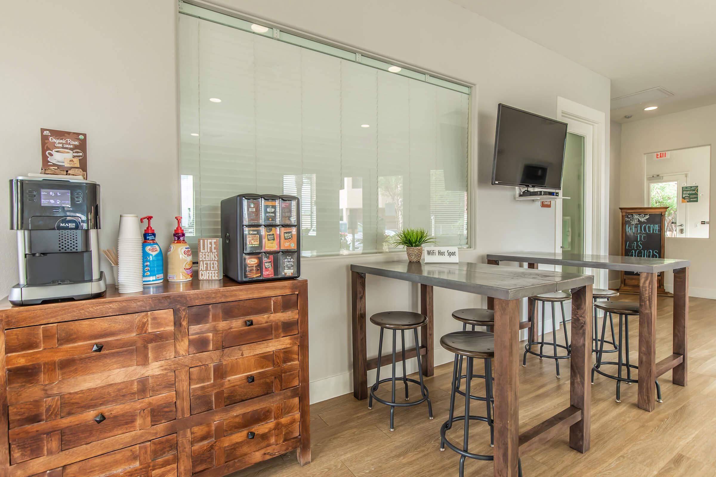 a kitchen with wooden cabinets and a table in a room