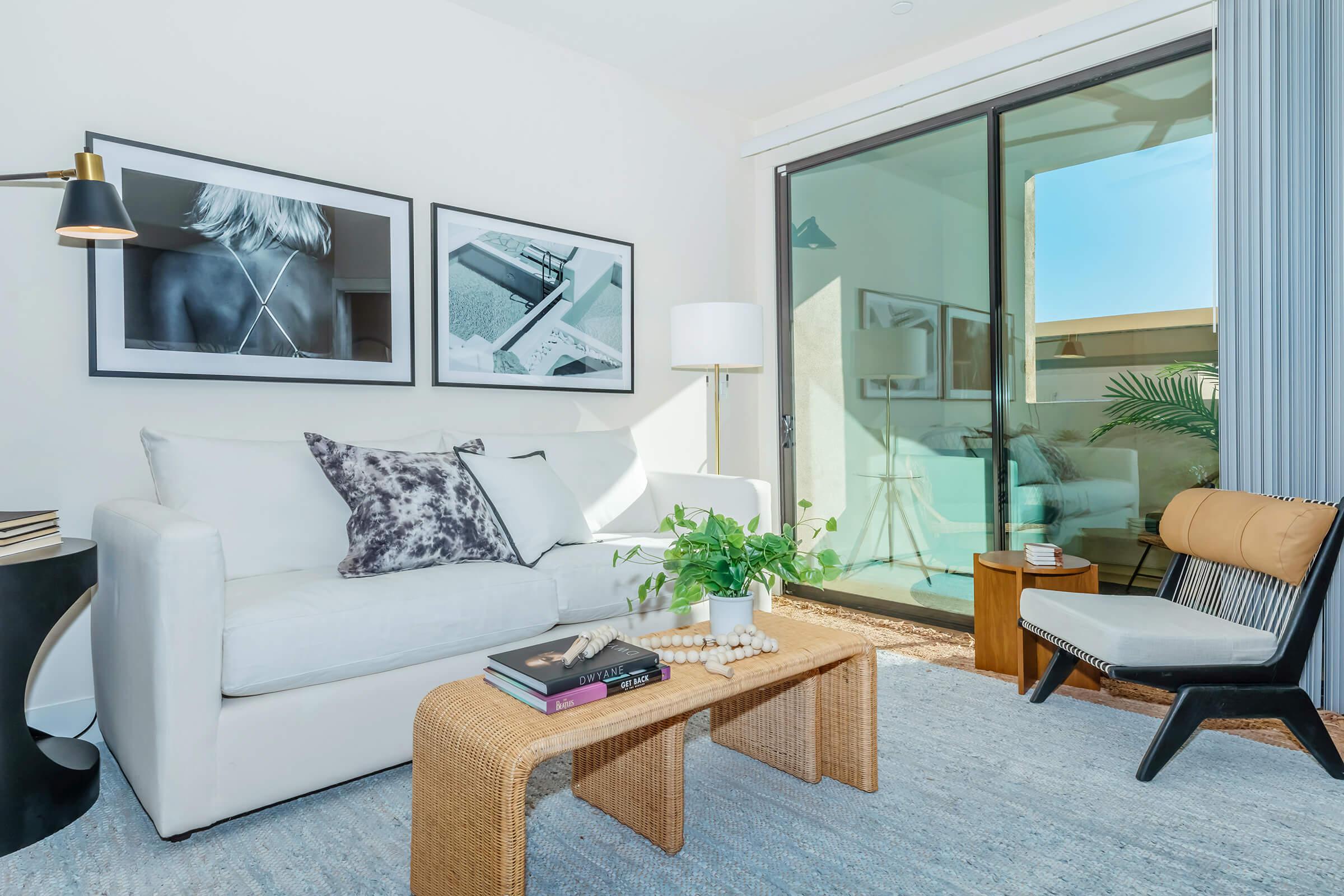 a living room filled with furniture and a large window