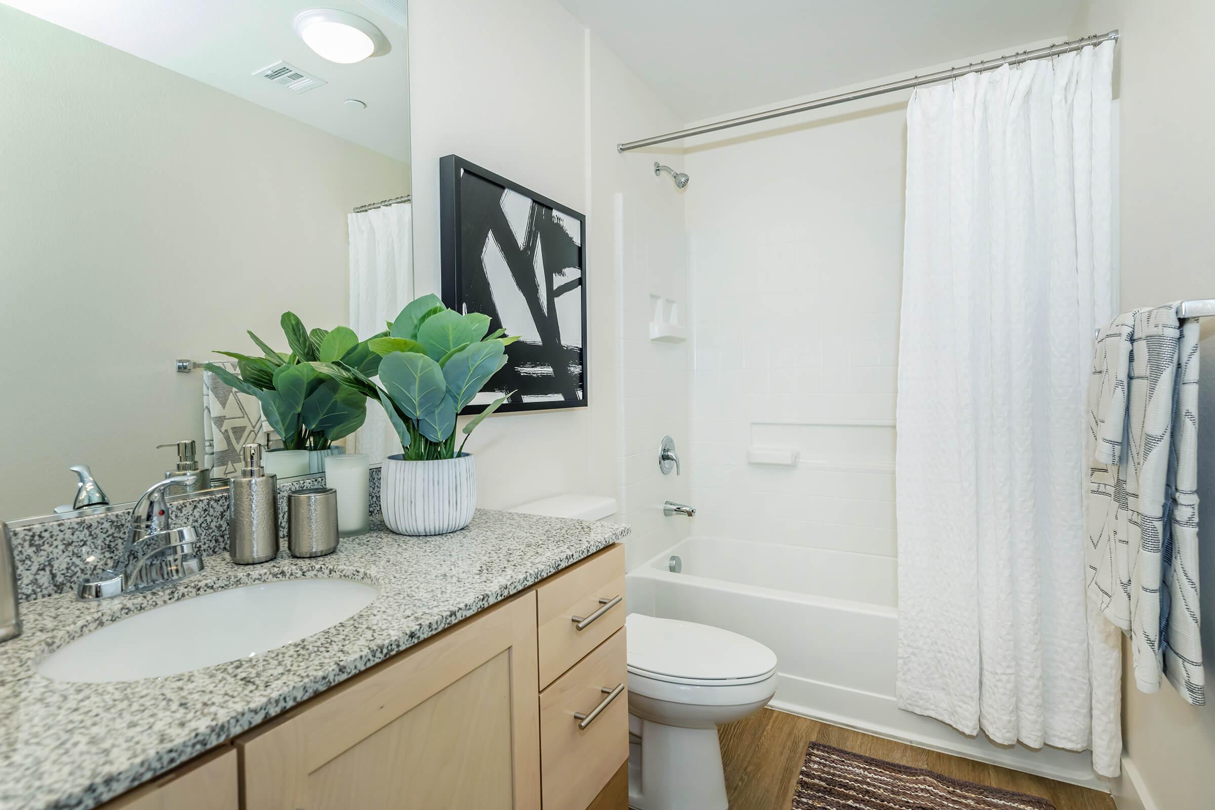 a bedroom area with a sink and a mirror