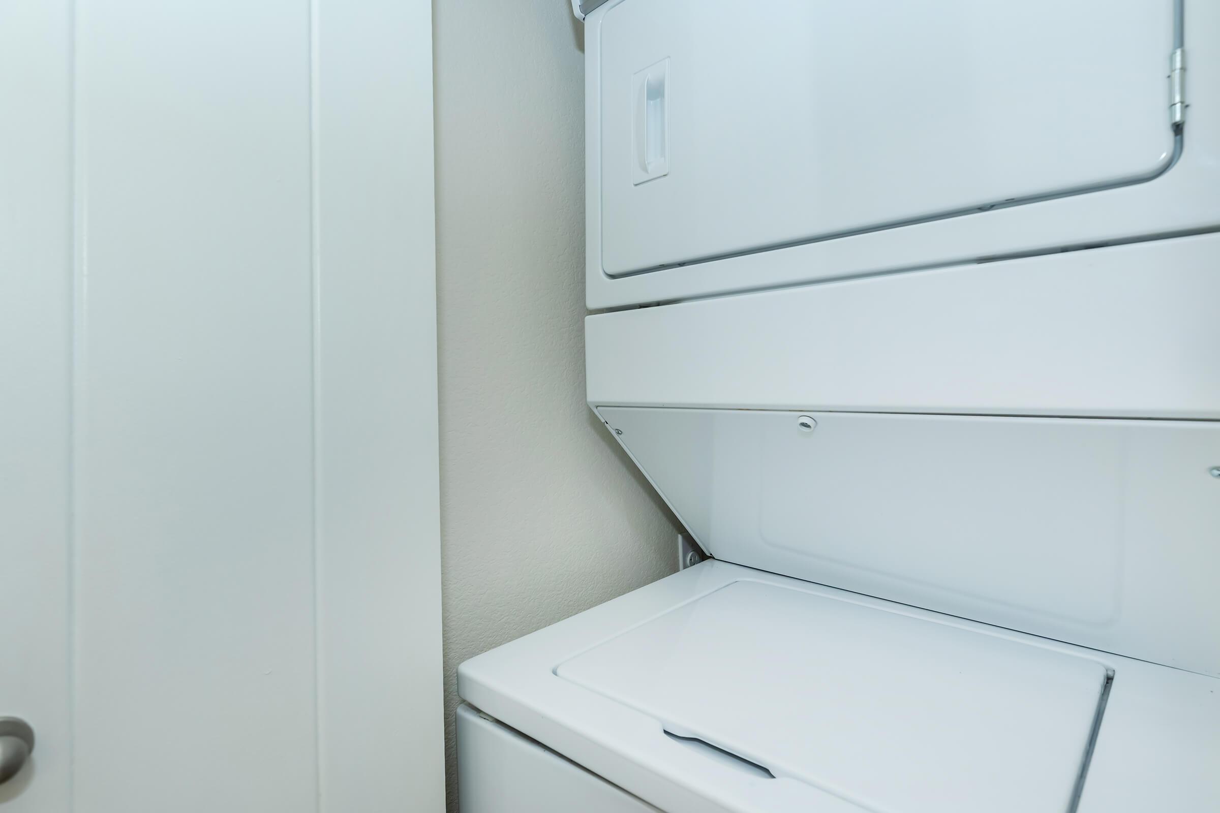 a microwave oven sitting on top of a refrigerator