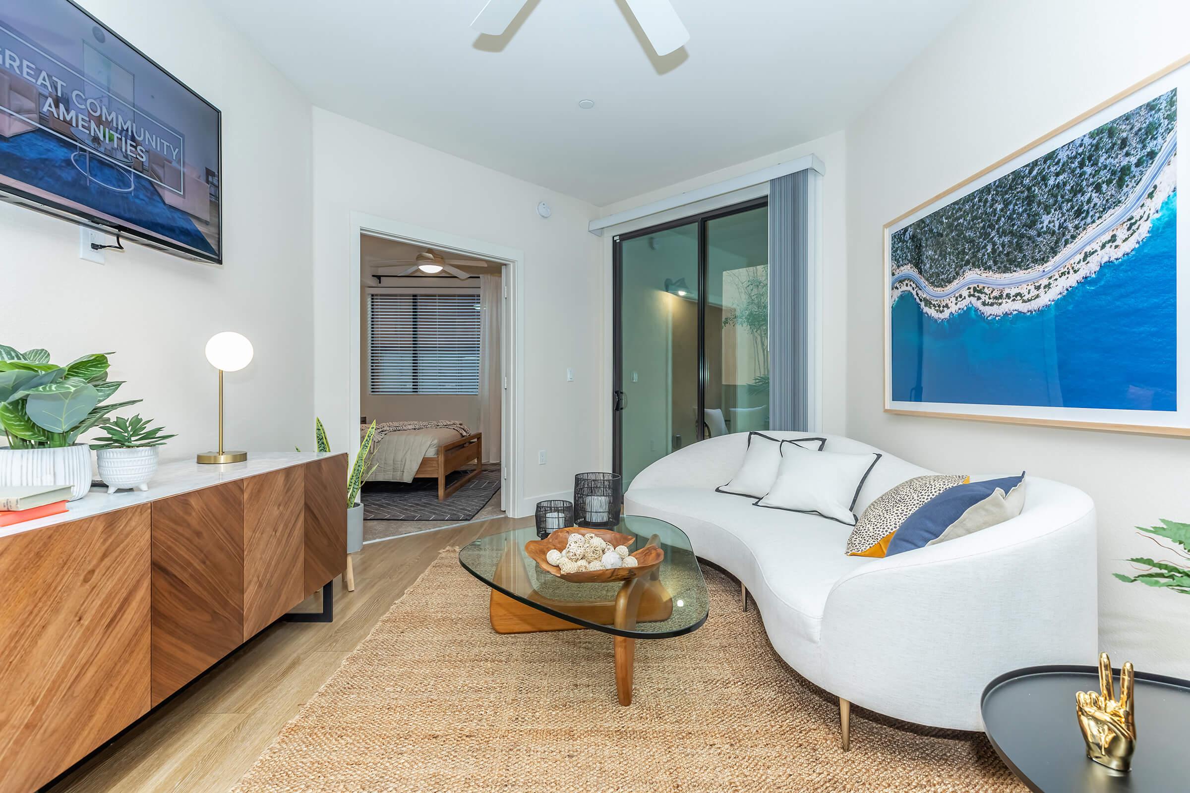 a living room filled with furniture and a large window