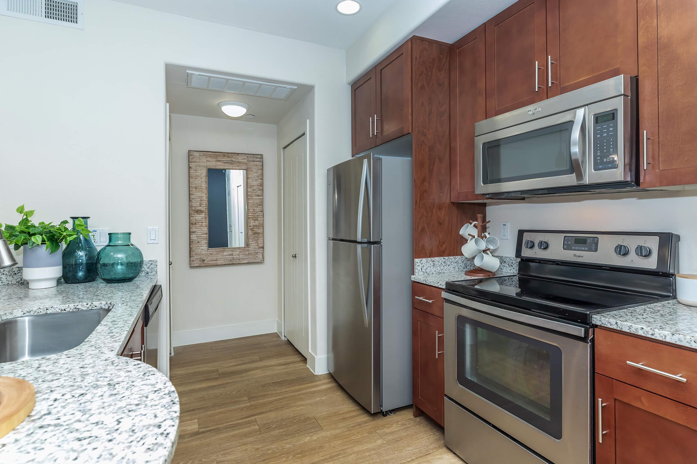 a stove top oven sitting inside of a kitchen