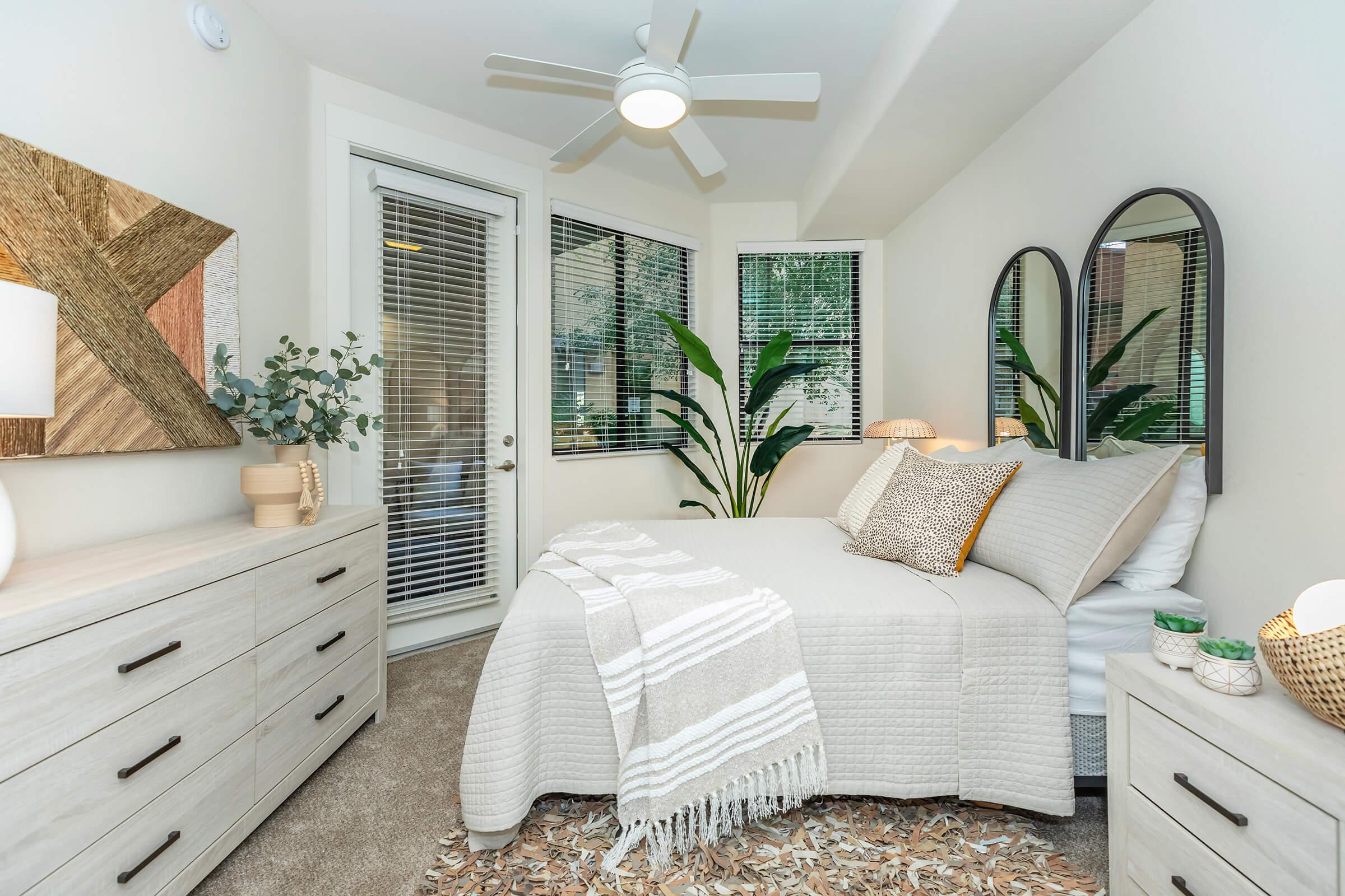 a living room with a bed and a mirror