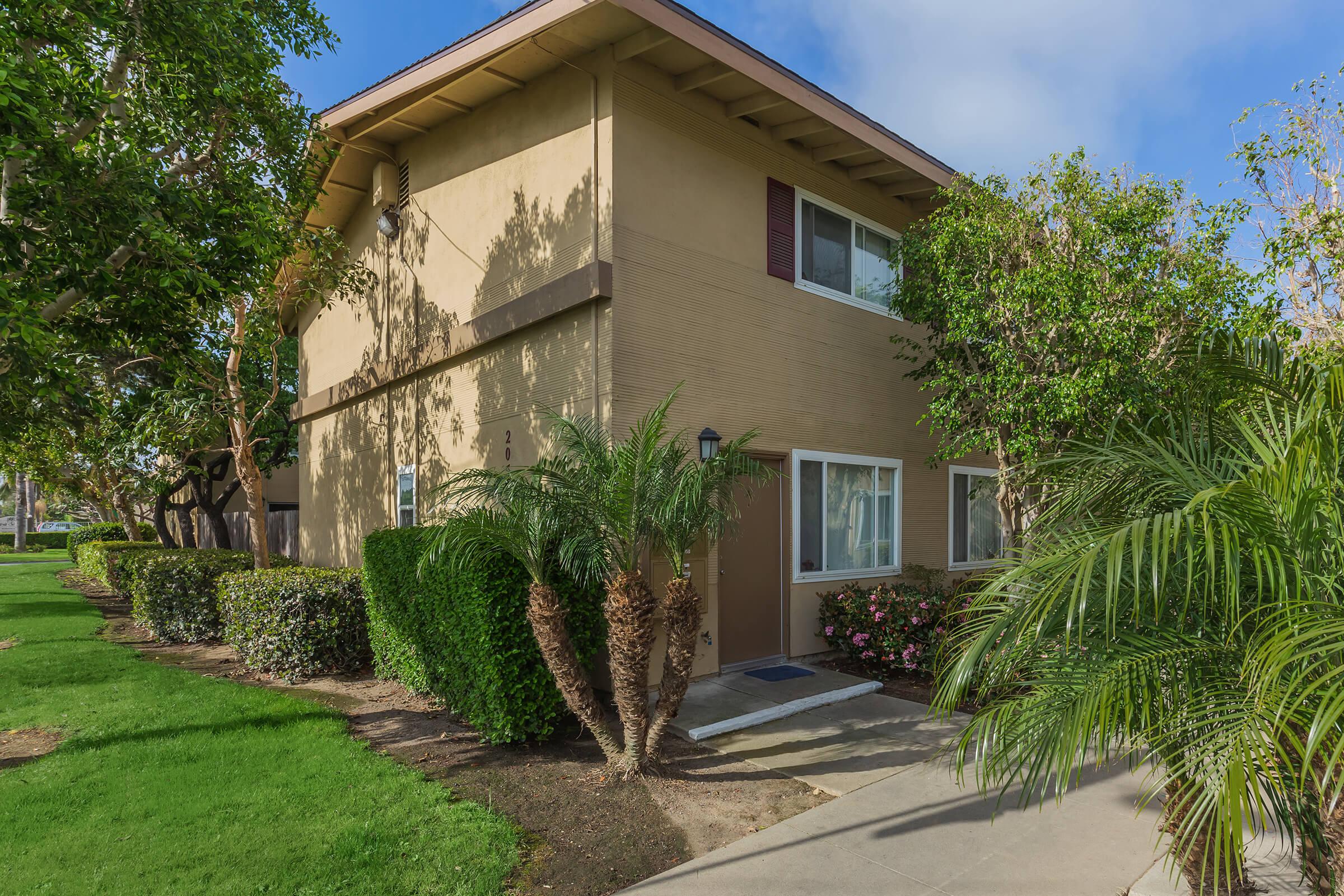 Woodhaven Townhomes community building with green grass