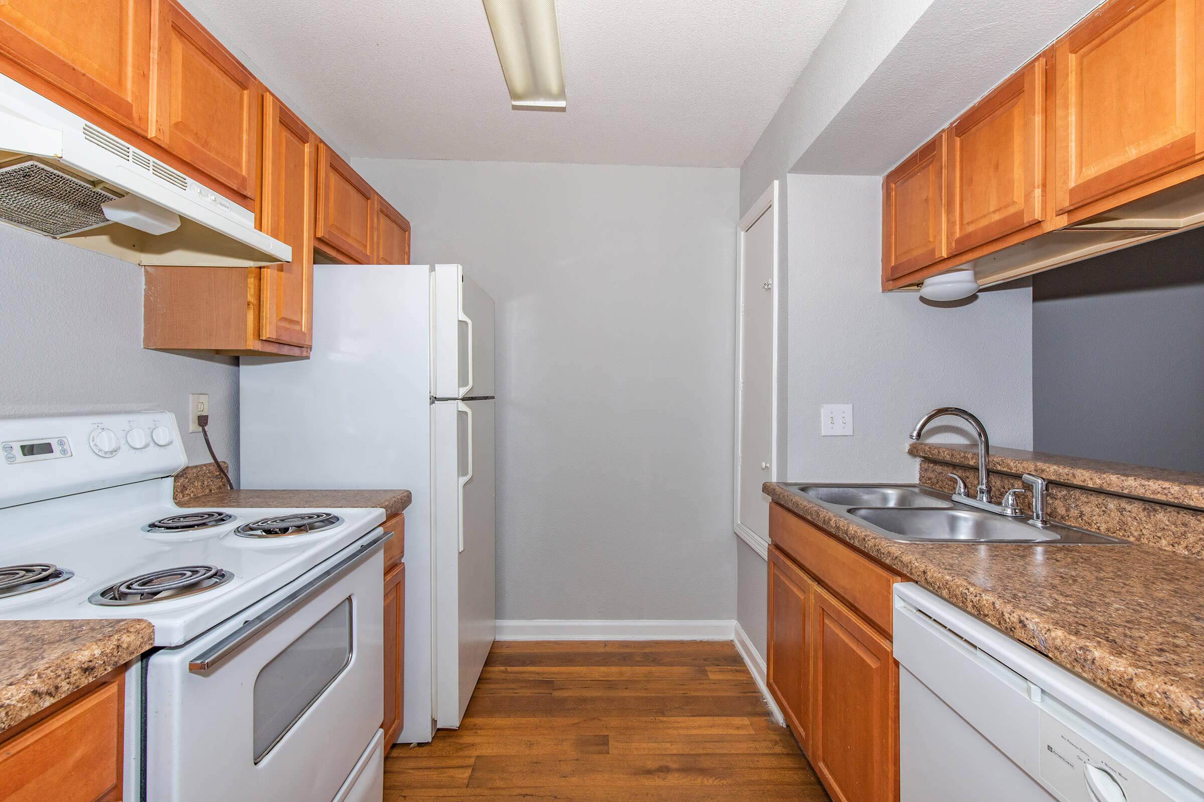 a kitchen with a stove sink and refrigerator