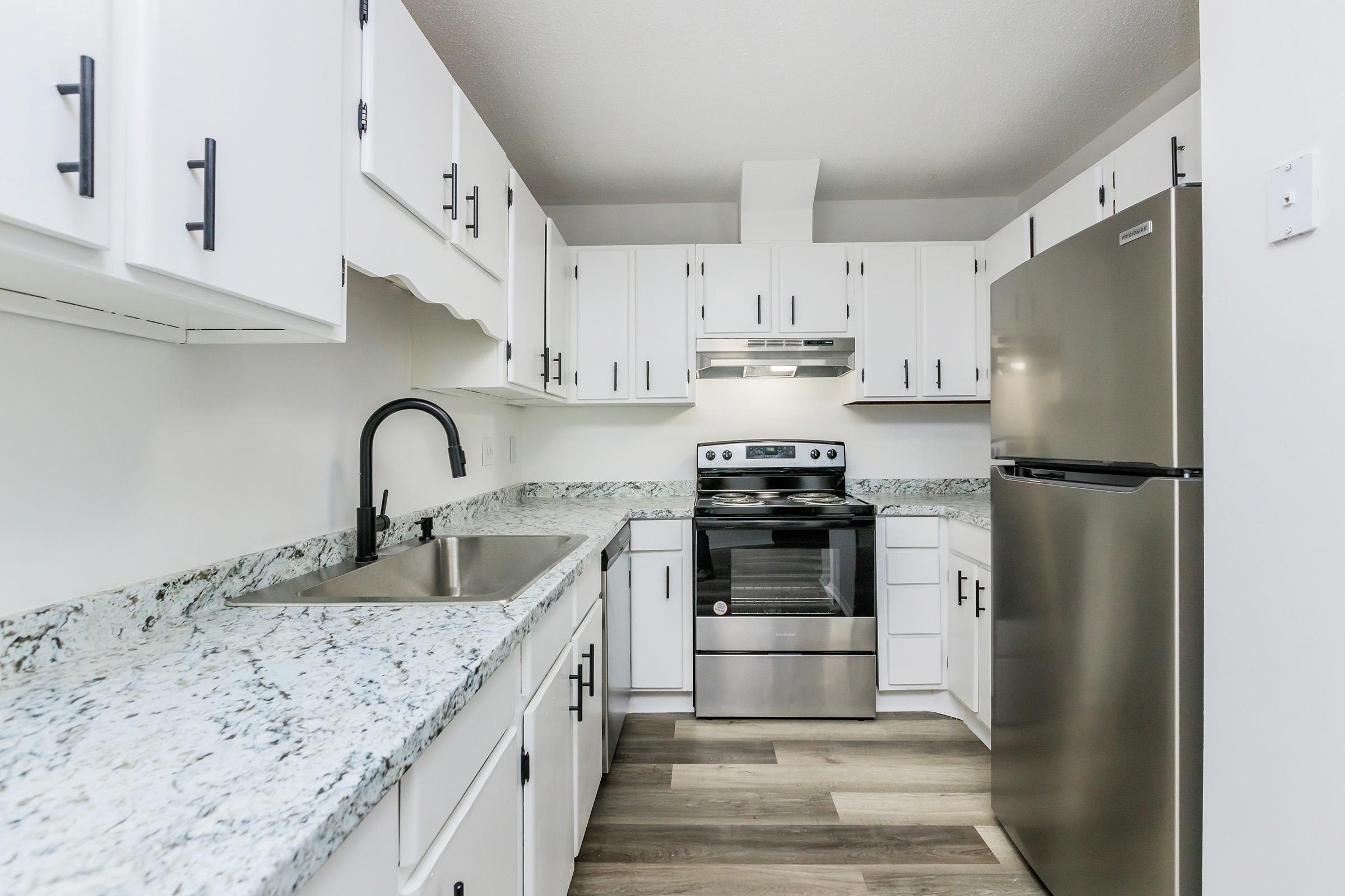 a kitchen with a stove and a refrigerator