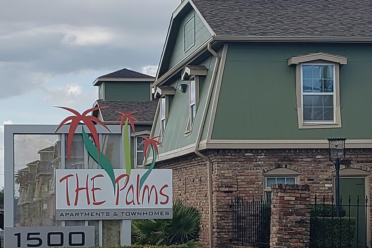 a house that has a sign on a brick building