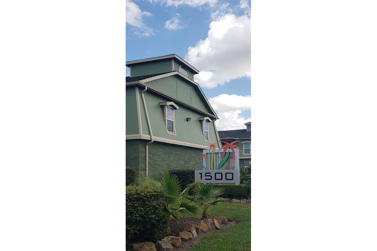 a house that has a sign on the side of a building