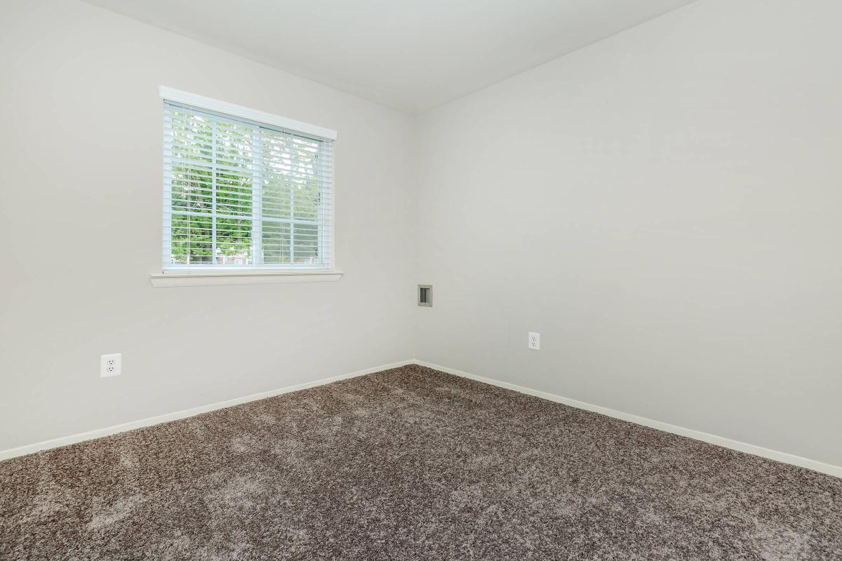 a bedroom with a large window
