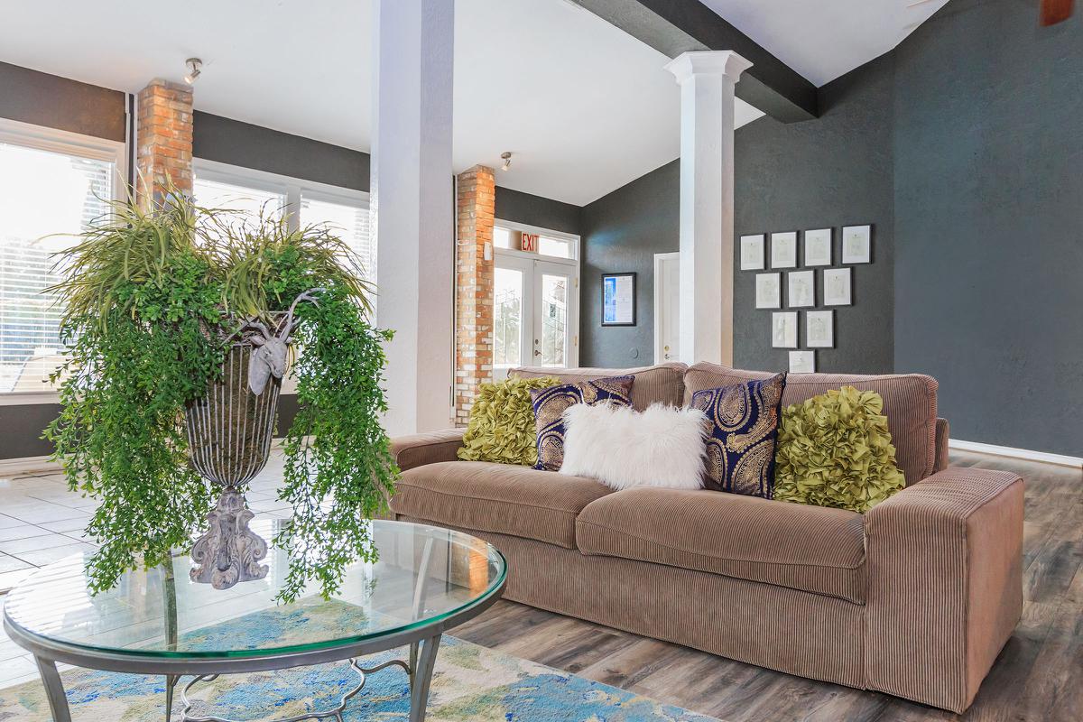a living room filled with furniture and vase of flowers on a table