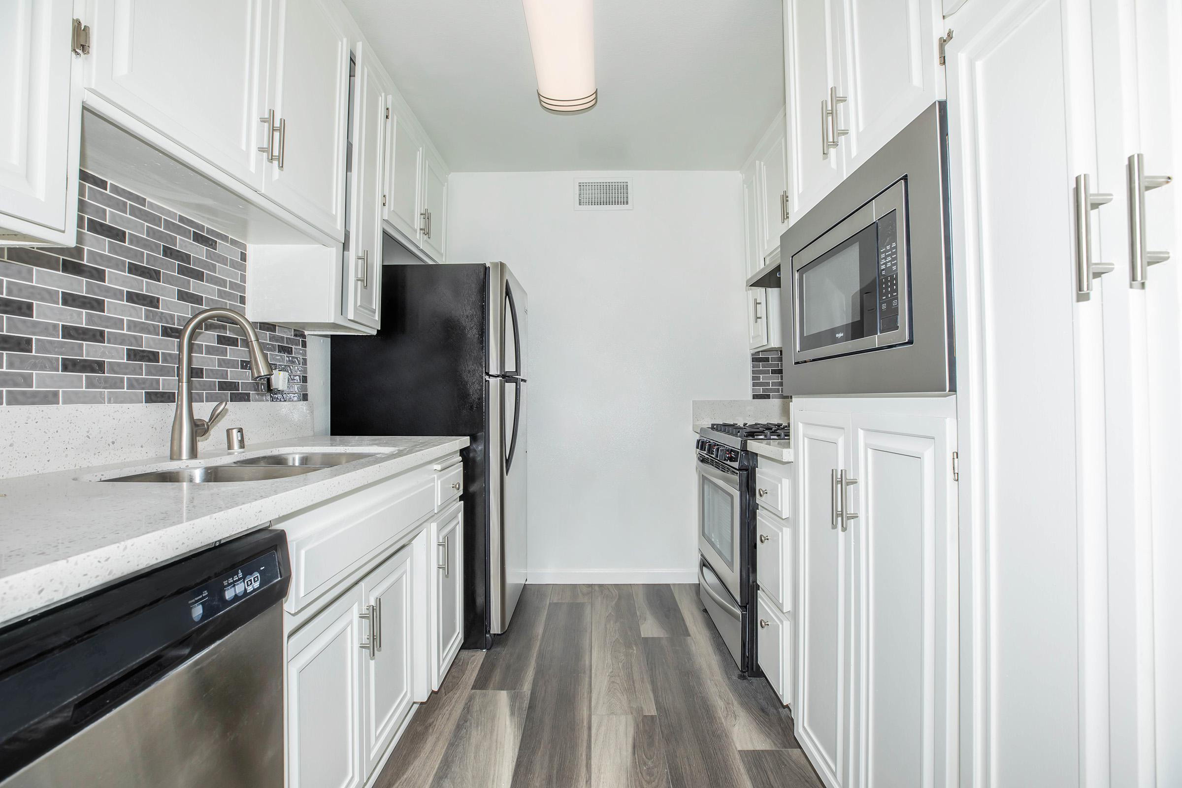 a kitchen with a sink and a refrigerator