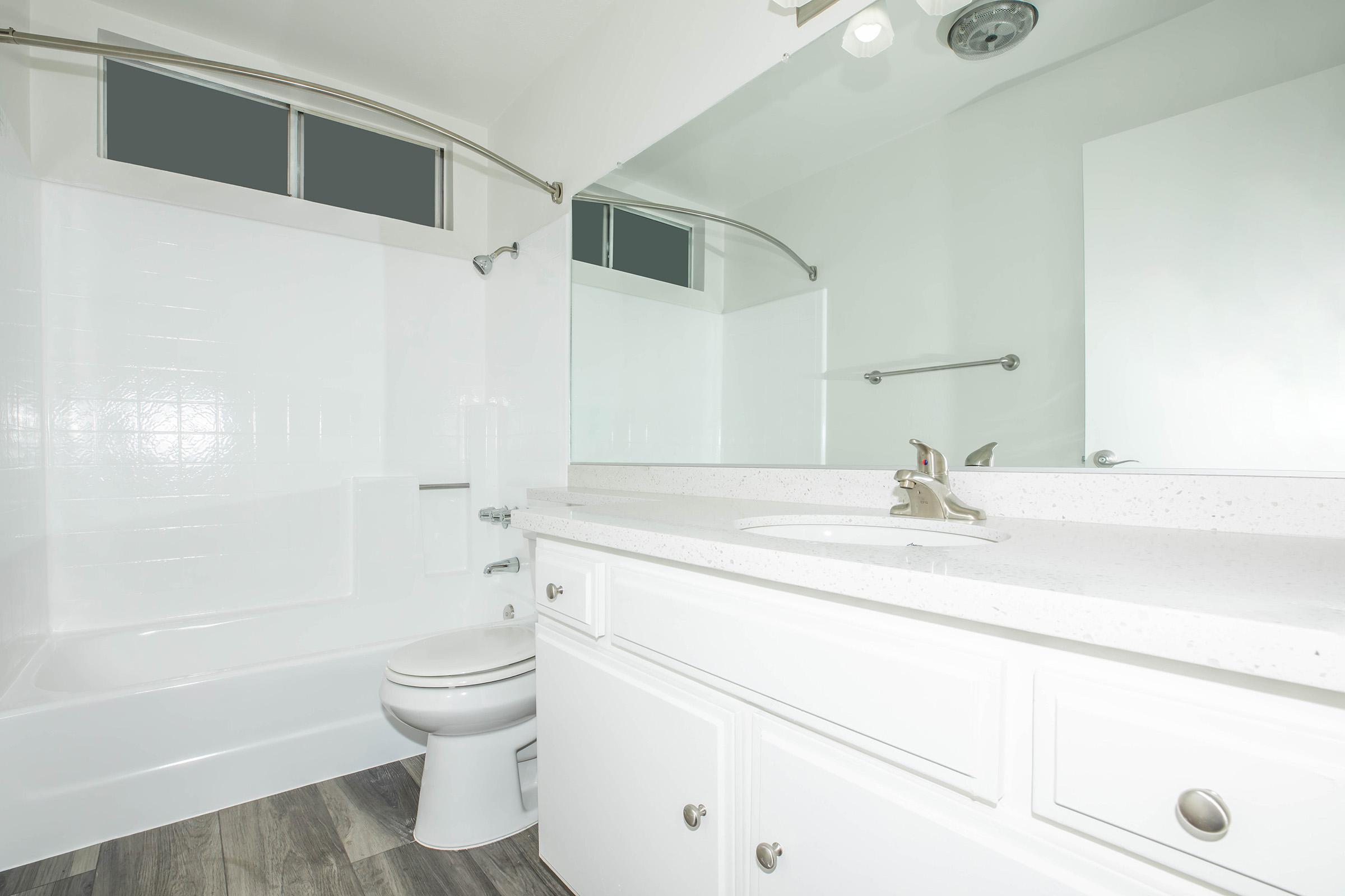 a white tub sitting next to a sink