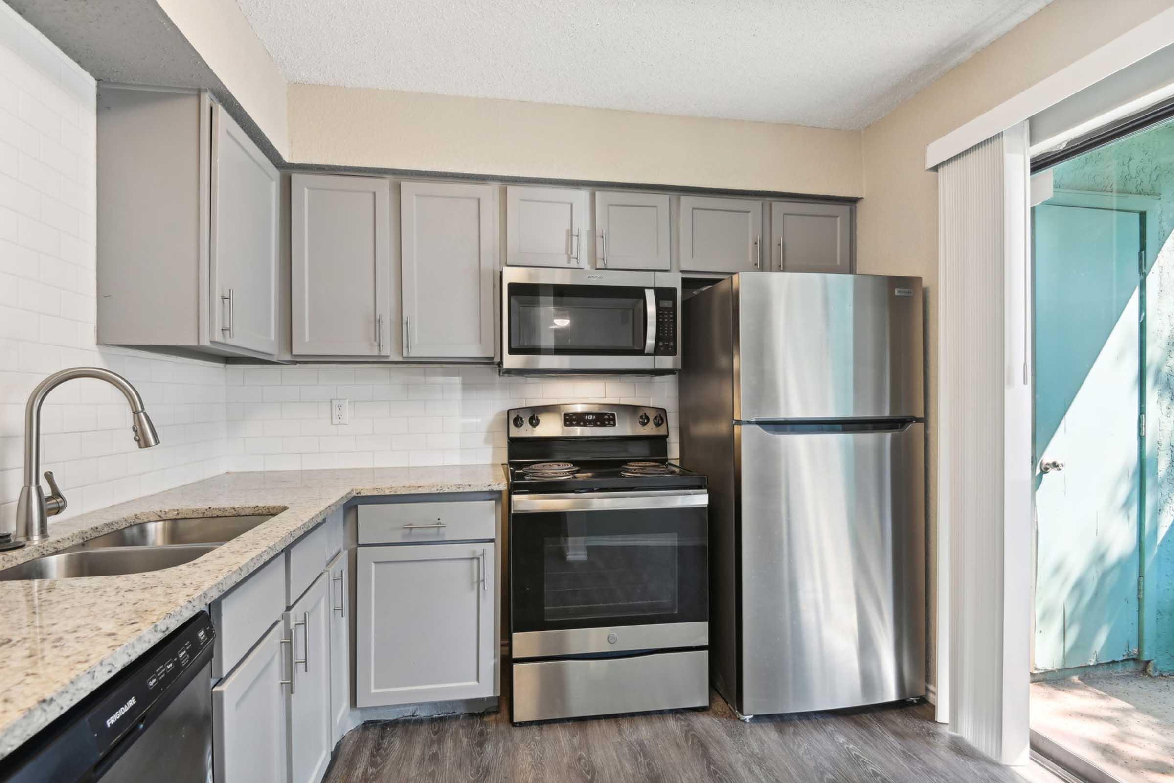 a large kitchen with stainless steel appliances