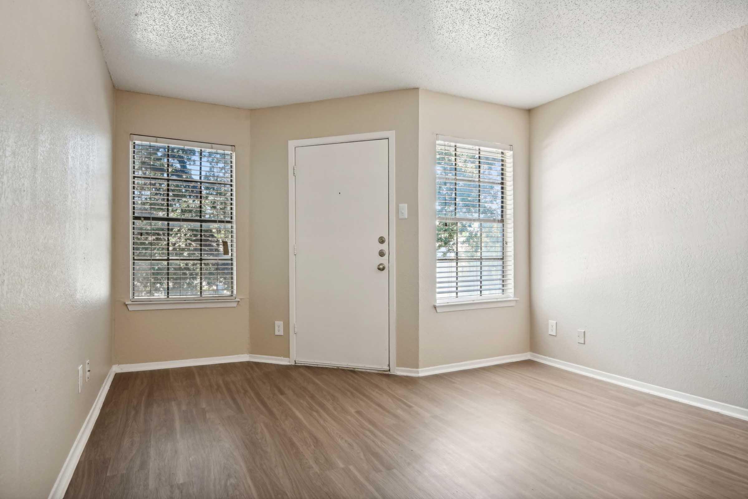 a large empty room with a wooden floor