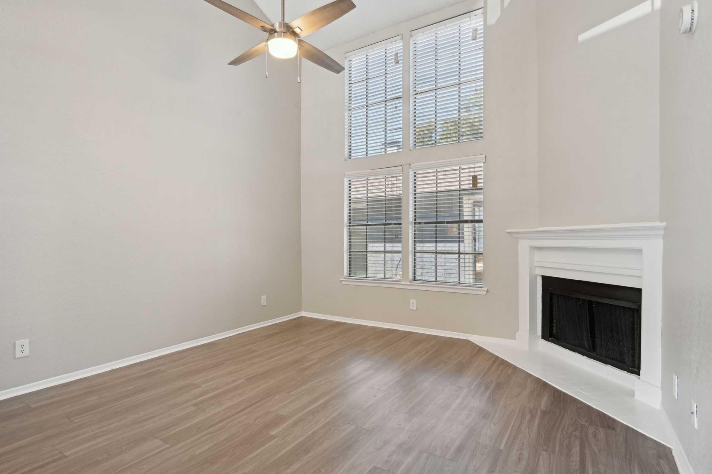 a living room with a fireplace and a large window