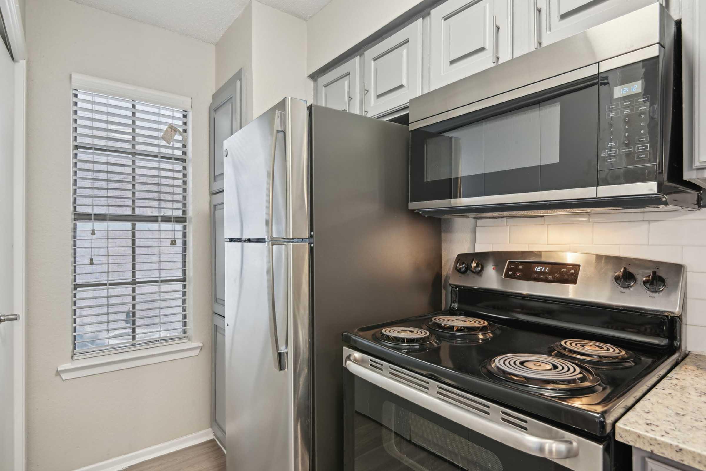 a stove top oven sitting inside of a kitchen