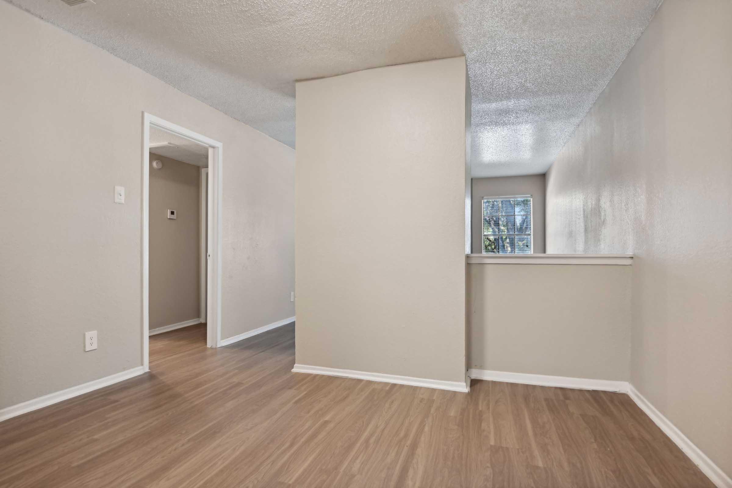 a large empty room with a wood floor