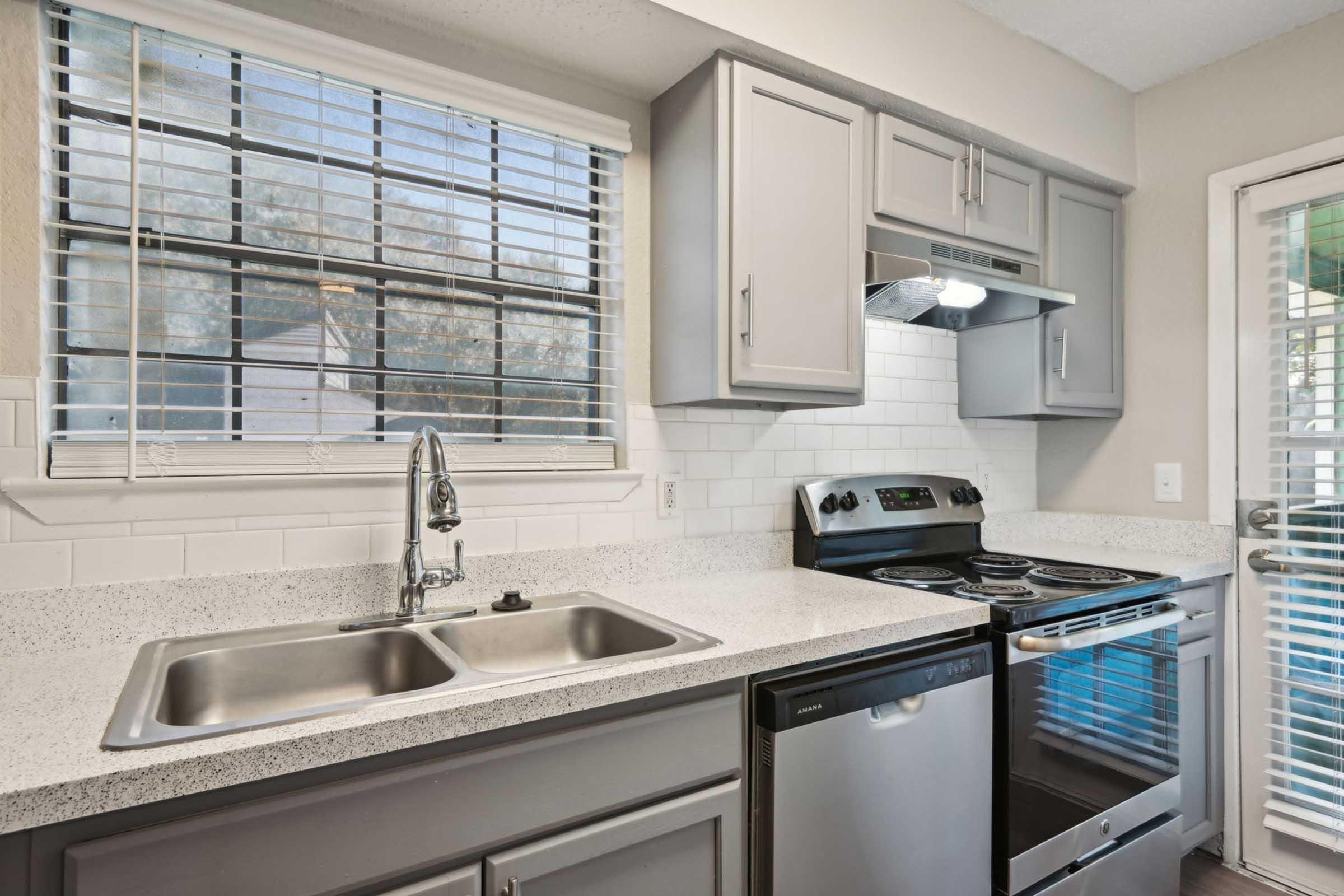 a kitchen with a sink and a window