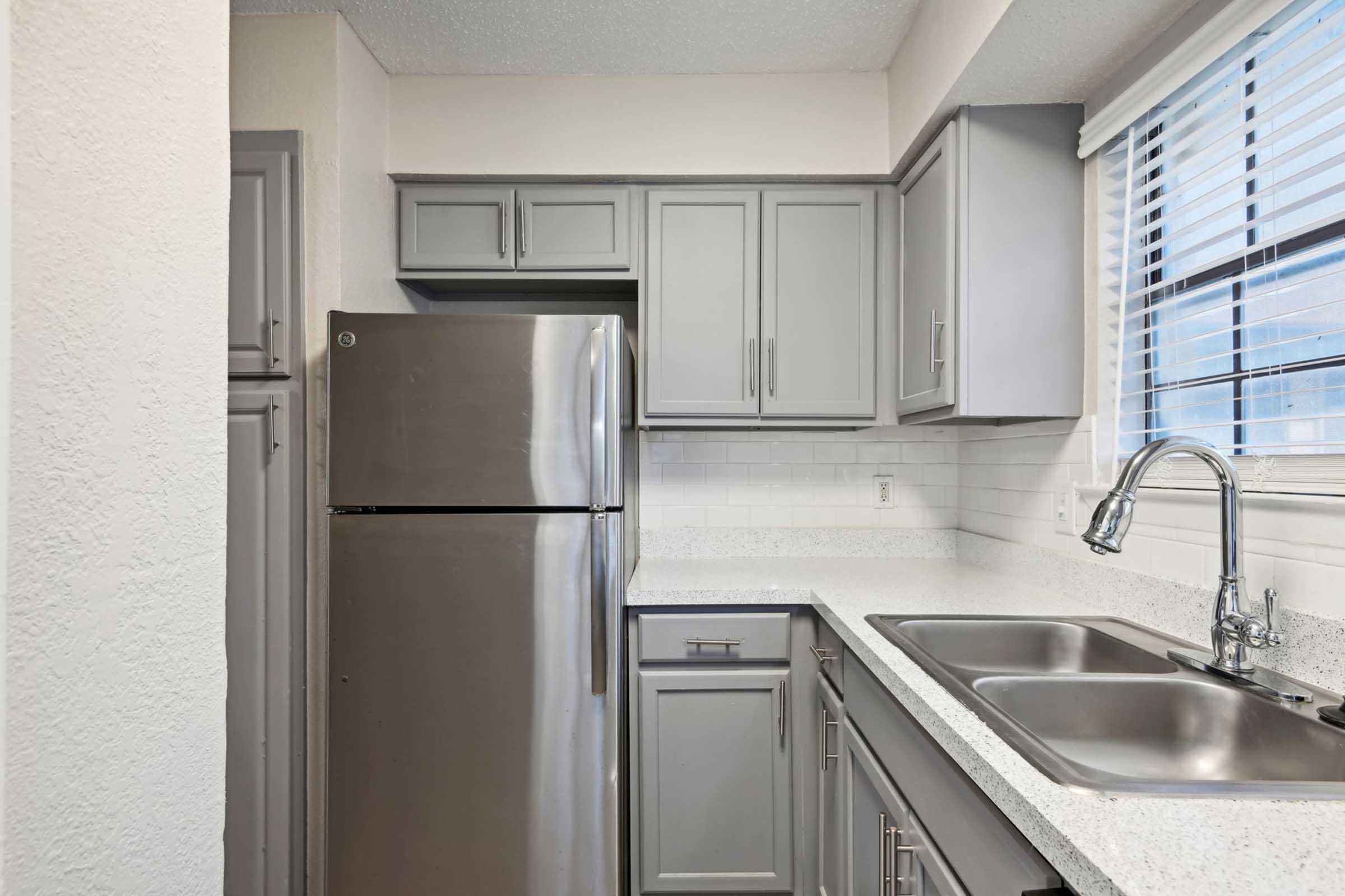 a stainless steel refrigerator in a kitchen