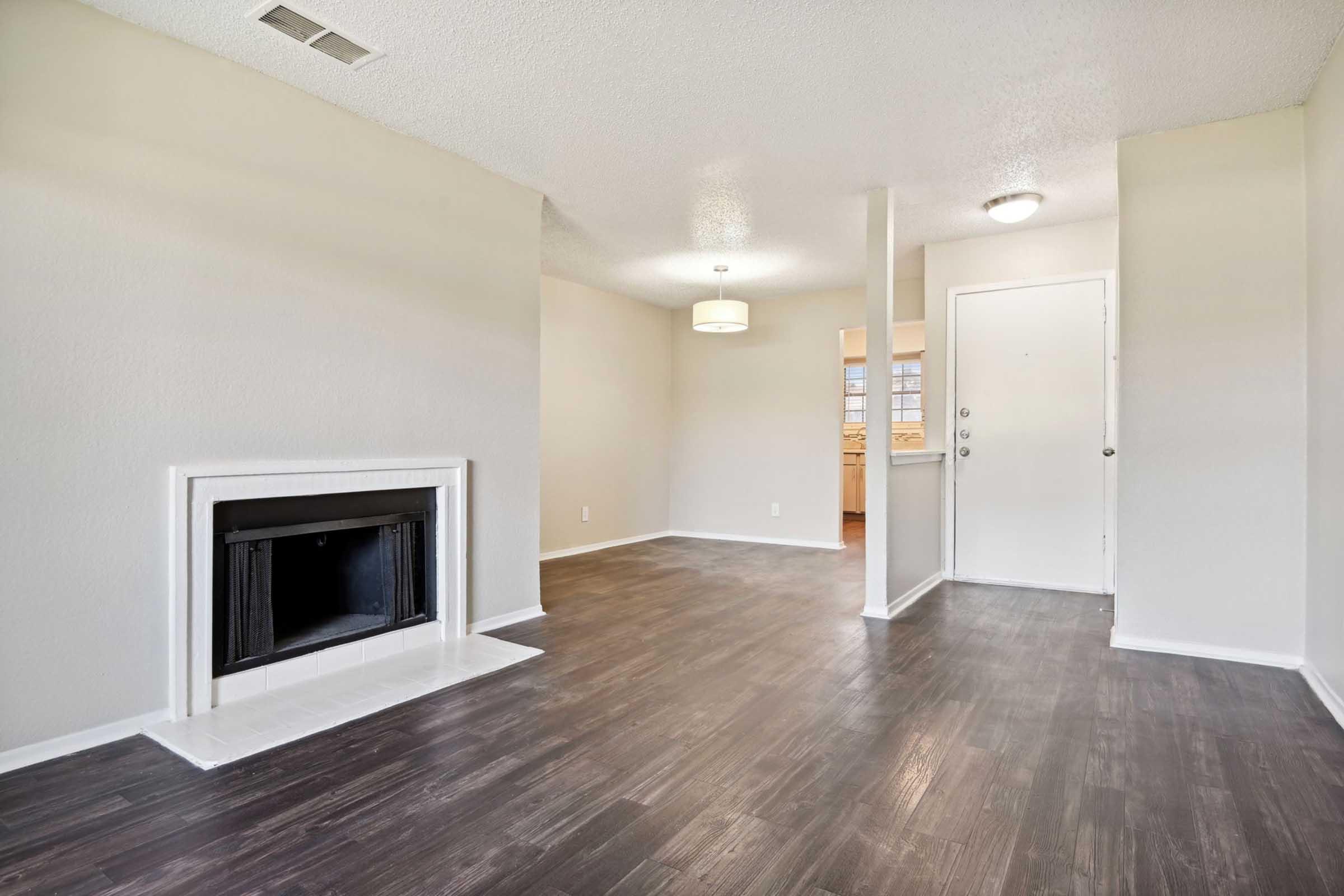 a large empty room with a wood floor