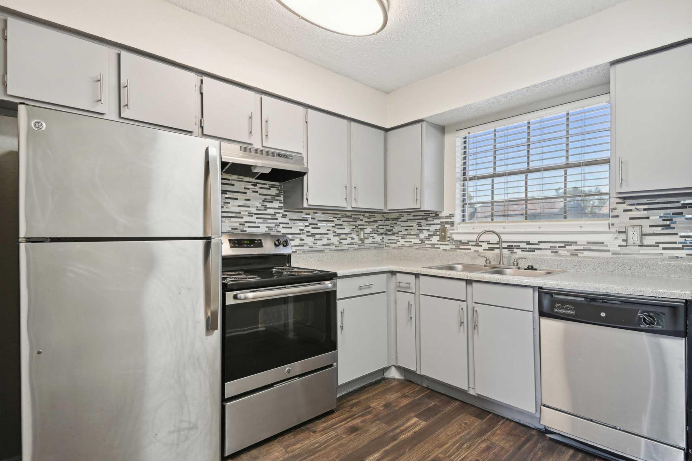 a kitchen with a stove sink and refrigerator