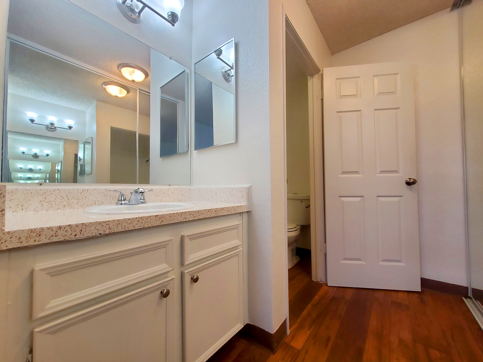 a kitchen with a sink and a mirror