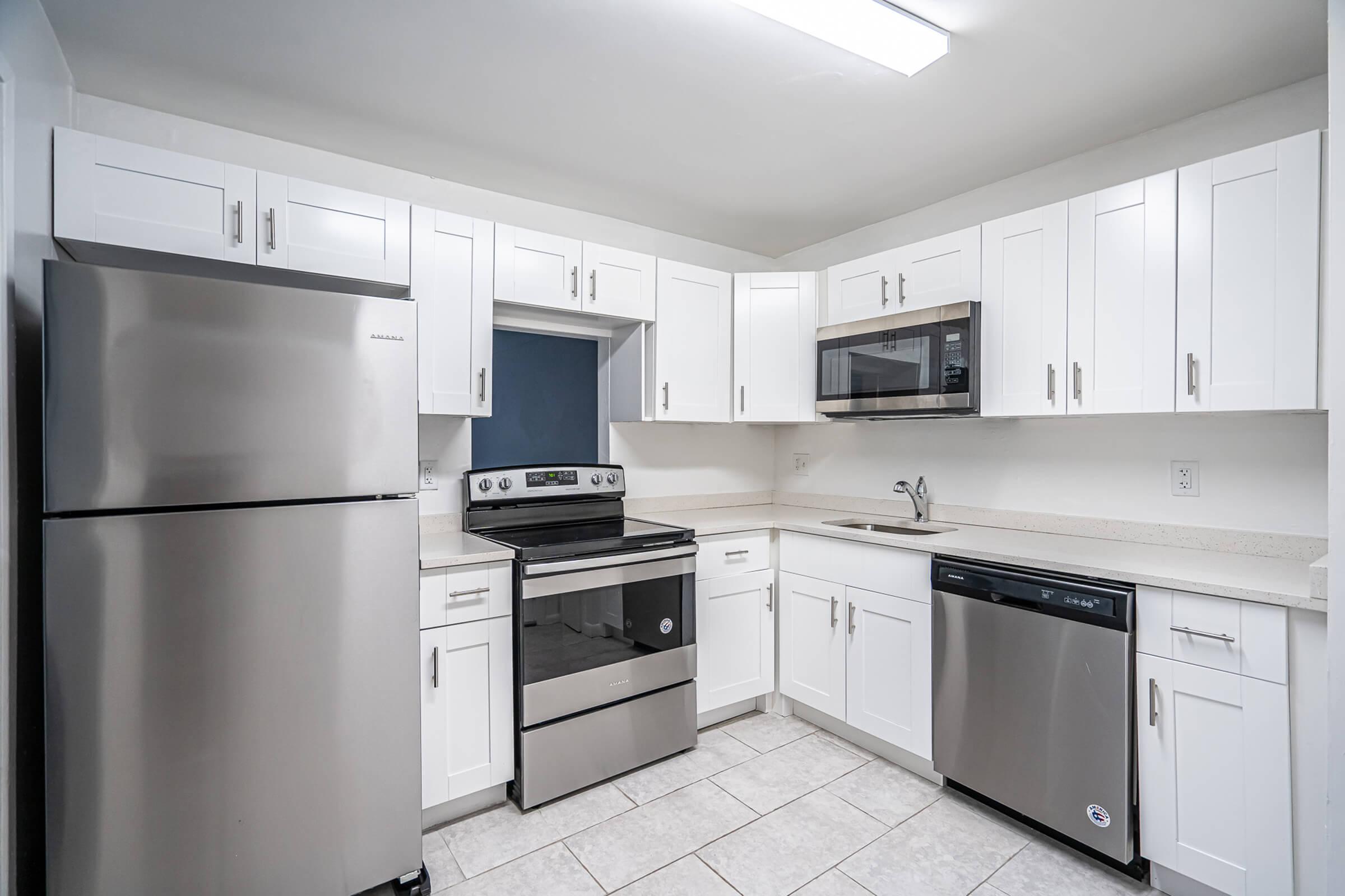 a kitchen with a stove and a refrigerator