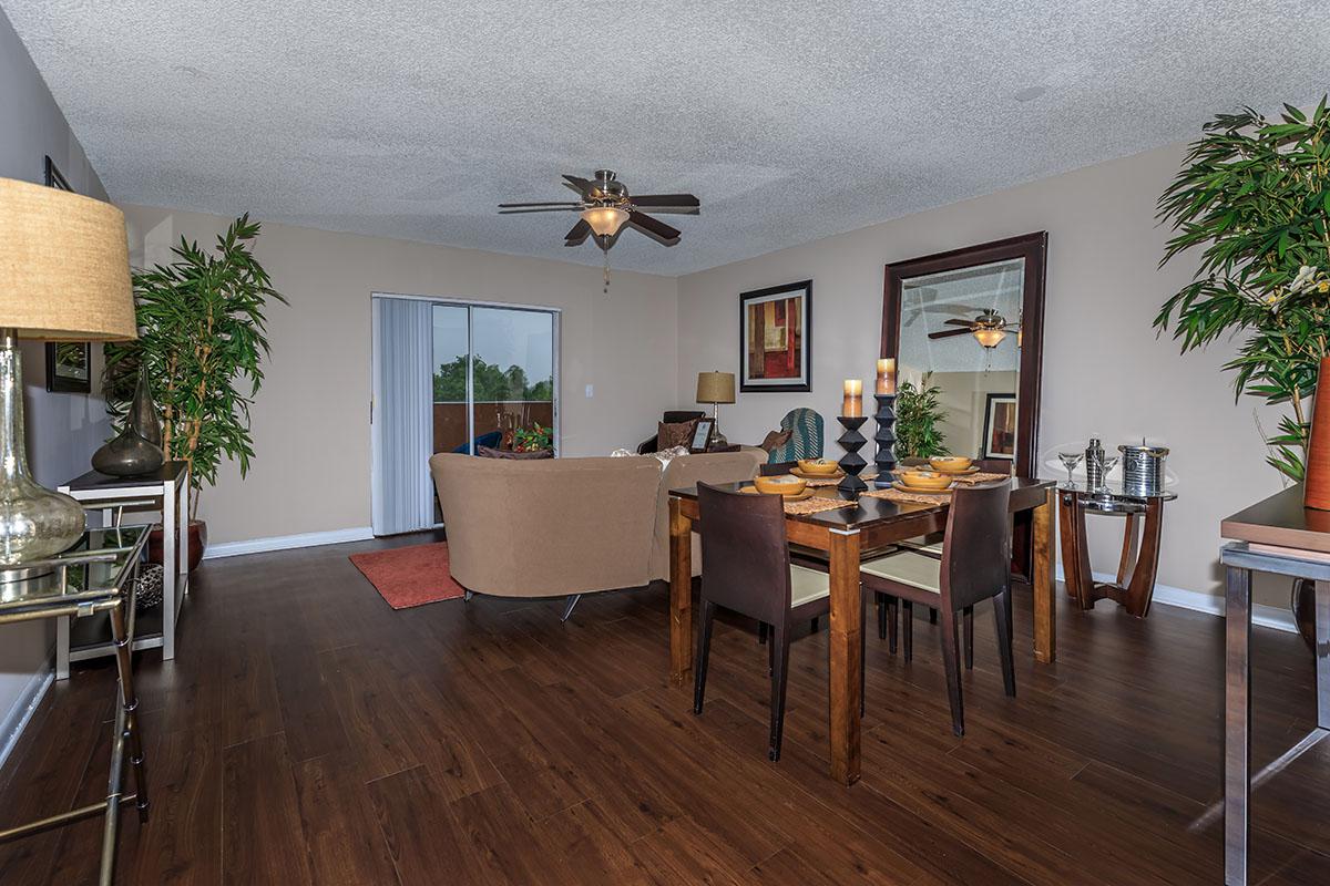 a living room filled with furniture on top of a wooden floor