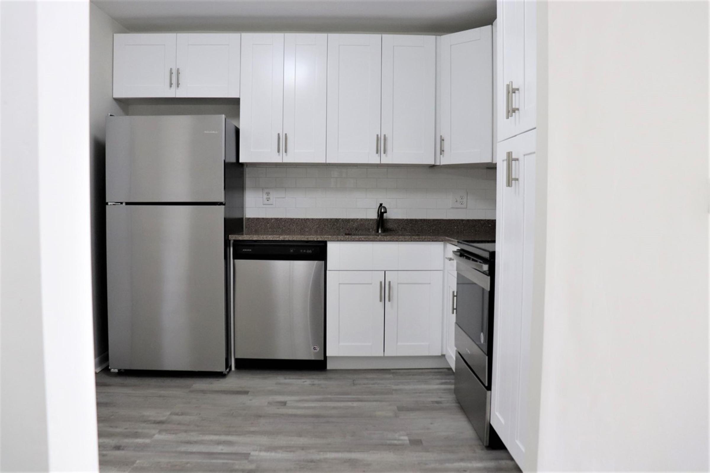 a white refrigerator freezer sitting inside of a kitchen