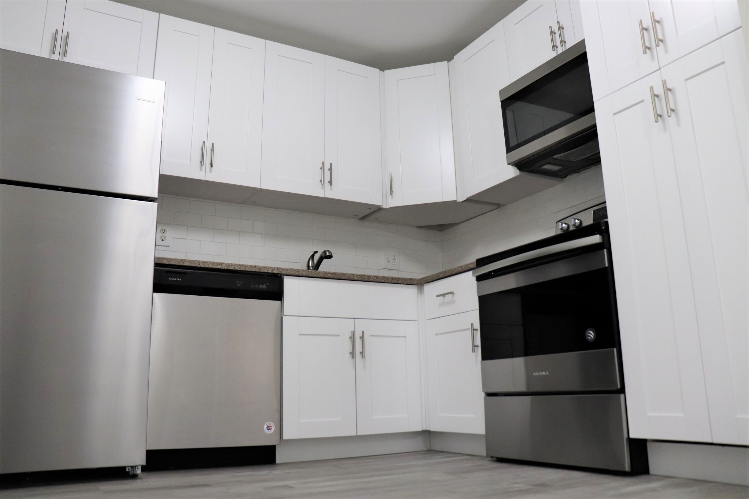a large white refrigerator in a kitchen