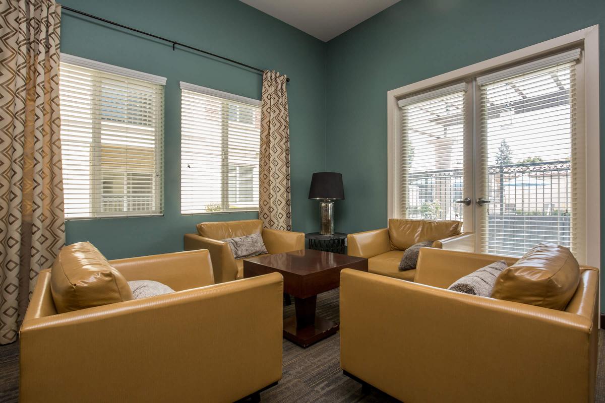 a living room filled with furniture and a large window