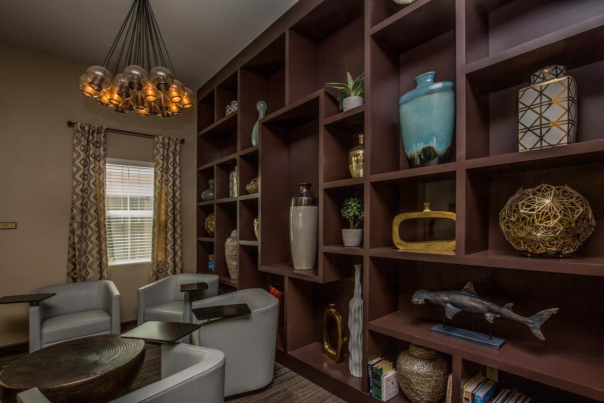 a room filled with furniture and vase of flowers on a table