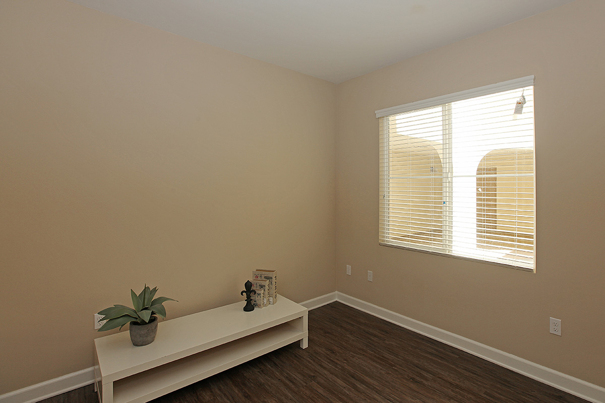 a bedroom with a large mirror next to a window