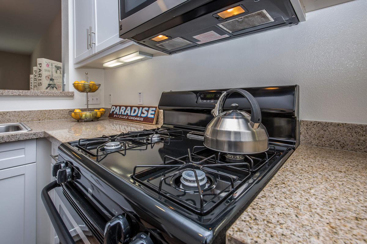 a stove top oven sitting inside of a kitchen